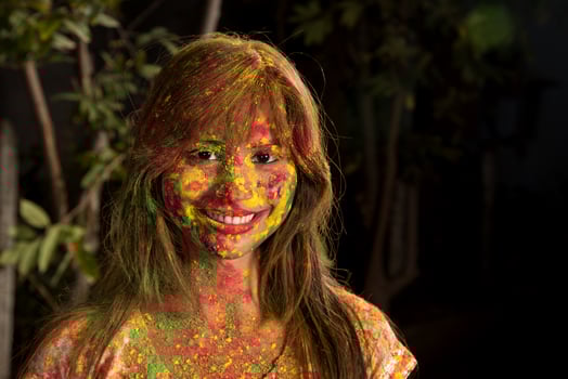 Portrait of a happy young girl on the festival of colors Holi. Girl posing and celebrating the festival of colors. photo