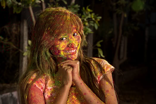 Portrait of a happy young girl on the festival of colors Holi. Girl posing and celebrating the festival of colors. photo