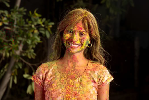 Portrait of a happy young girl on the festival of colors Holi. Girl posing and celebrating the festival of colors. photo