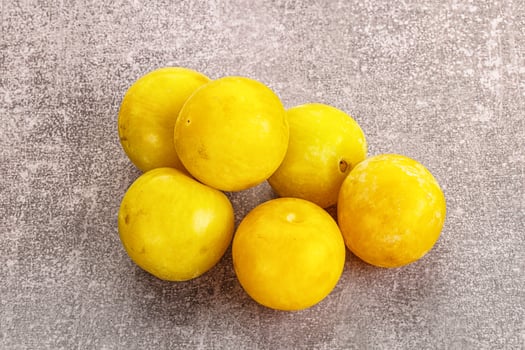 Yellow sweet plum heap fruit photo