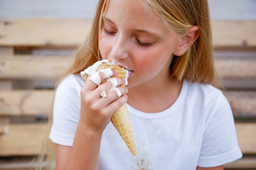 The child stained his clothes with ice cream. photo