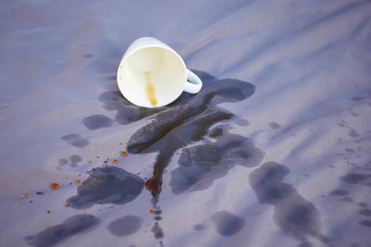Spilled coffee on a gray bed. photo