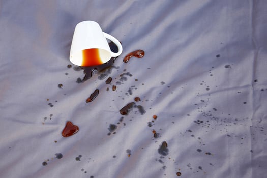 Spilled coffee on a gray bed. photo