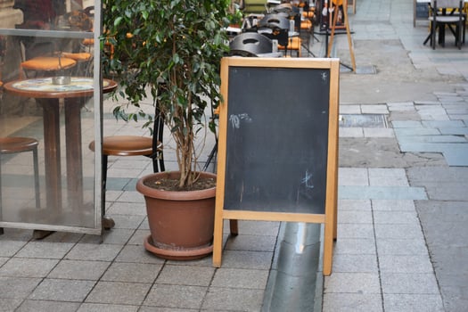 Chalkboard Sign Outside a Caf in a Charming Street View photo