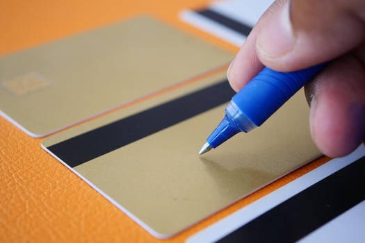 This is the process of Hand Writing on Luxury Gold Credit Cards using a Blue Ink Pen photo