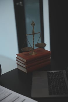 A laptop, a scale, and a book on a desk photo