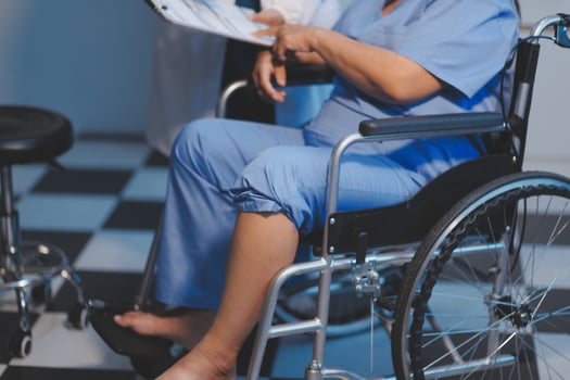 Asian young professional successful friendly female nurse in blue hospital uniform helping supporting physical therapy senior old pensioner unhealthy injury woman patient walking via four legs walker. photo