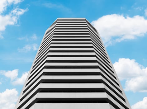 Bottom up view white office building with blue sky background photo