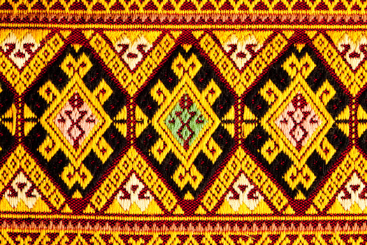 Closeup view pattern of beautiful ancient Thai woven cloth. photo