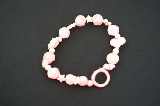 A beaded bracelet on a black surface. photo