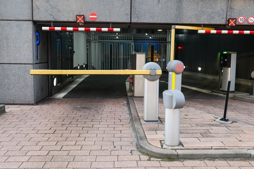 Barrier at the parking lot exit of a building. View of a car barrier gate at the entrance of a building. photo