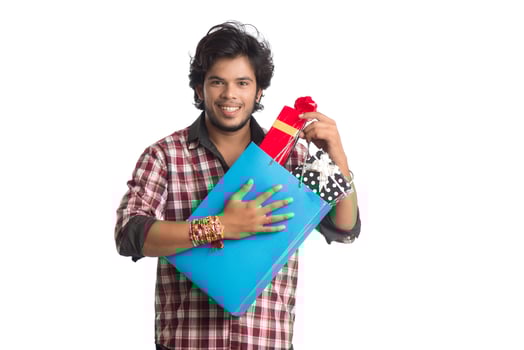 Young men showing rakhi on his hand with shopping bags and gift box on the occasion of Raksha Bandhan festival. photo