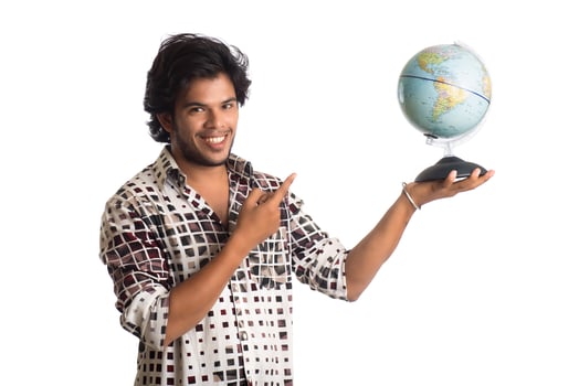 young man with a world globe on a white background. photo