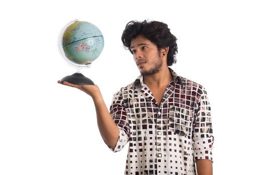 young man with a world globe on a white background. photo