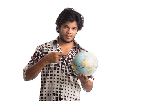 young man with a world globe on a white background. photo