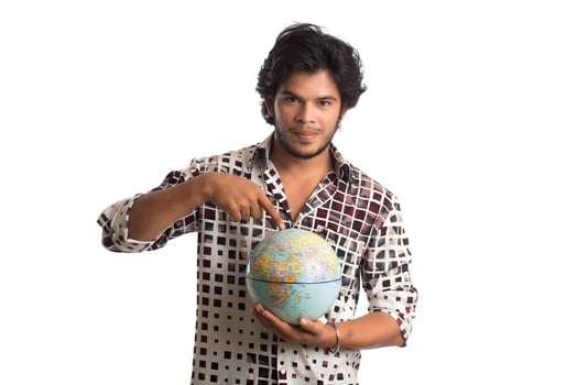 young man with a world globe on a white background. photo