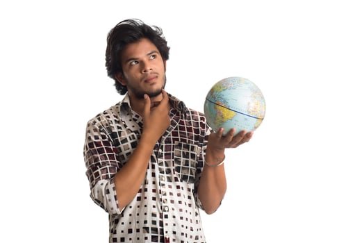 young man with a world globe on a white background. photo