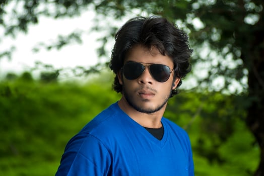 Handsome fashion young man posing outdoors photo