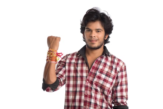 Young men showing rakhi on his hand on an occasion of Raksha Bandhan festival. photo