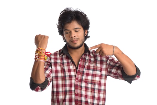 Young men showing rakhi on his hand on an occasion of Raksha Bandhan festival. photo
