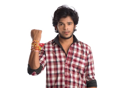 Young men showing rakhi on his hand on an occasion of Raksha Bandhan festival. photo