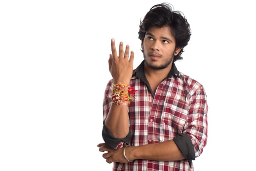 Young men showing rakhi on his hand on an occasion of Raksha Bandhan festival. photo