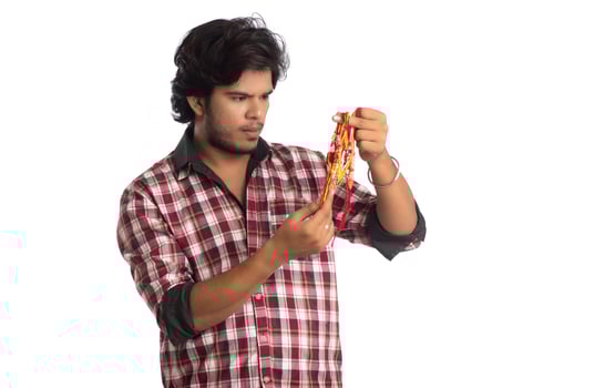 Young men showing rakhi in hand and giving expression on an occasion of Raksha Bandhan festival. photo