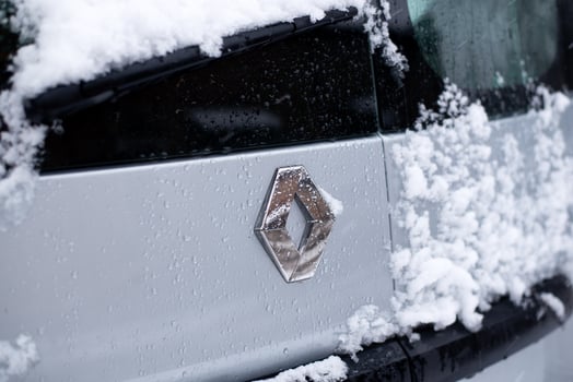 Kyiv, Ukraine. 21 November, 2024. Renault car logo covered in snow and water droplets during winter weather photo