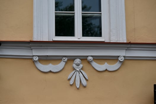 a window with decorative trim on the side of the building photo