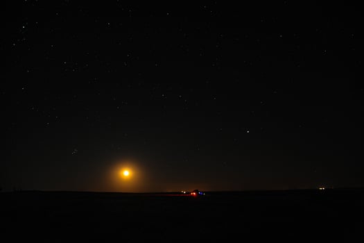 The moon is shining very brightly in the clear night sky tonight photo