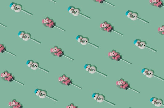 Christmas pattern made of Santa Claus and snowman lollipops on pastel green background. Minimal Christmas and New Year sweet candy concept. Creative festive pastel backdrop. Winter holiday idea. photo