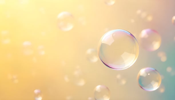 soap bubbles floating in the air on a yellow background photo