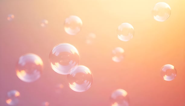 soap bubbles floating in the air on a pink background photo