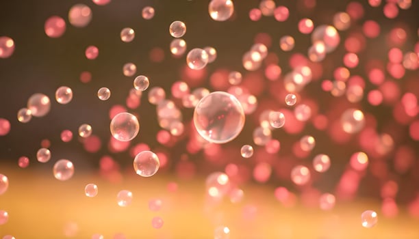 bubbles floating in the air with a pink background photo