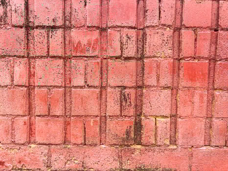 Old Red Brick Wall with Black Stains and Erosion, Perfect for Rustic and Industrial Background Designs photo