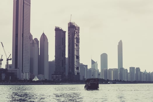 Abu Dhabi buildings skyline with old fishing boat photo