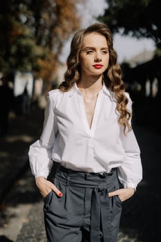 Businesswoman walking down the street on a sunny day photo