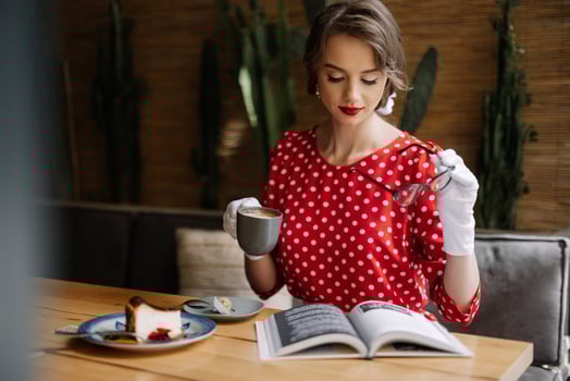 Elegant woman enjoying coffee and book in cafe photo