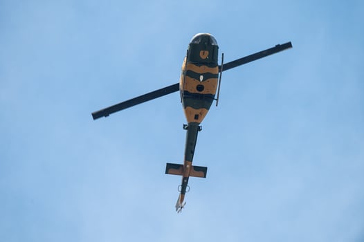 Military helicopter flying in the sky. photo