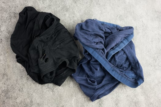 Blue and black torn underwear pants from a long time wearing. photo