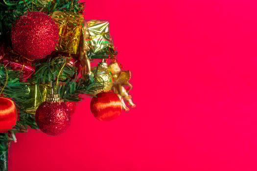 Christmas tree with ornaments on red background photo