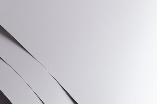 Gray paper background with a sleek monochrome texture and subtle geometric lines. Featuring soft photo
