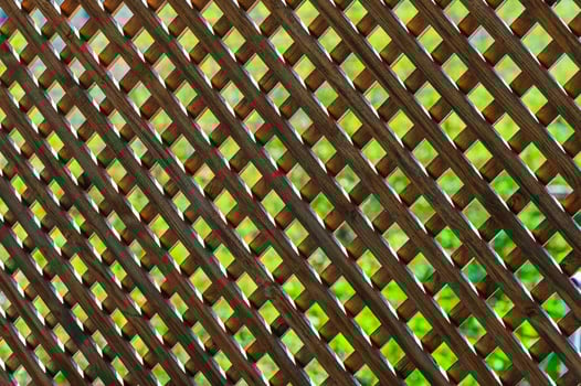 Lattice work casting shadows over vibrant green grass in a serene outdoor setting photo