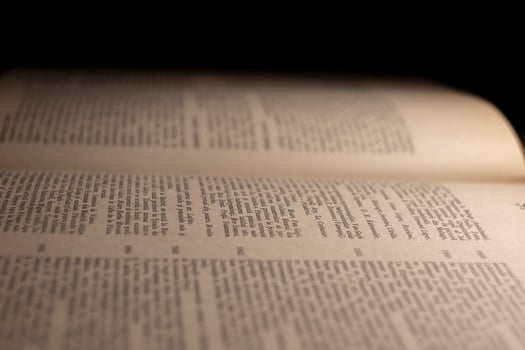 macro photography of a book page with text in Latin font photo