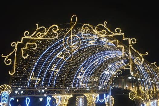 Christmas street arch, equipped with many yellow and blue lights. Festive New Year's element of city street decor in the evening. Russia, Moscow. photo