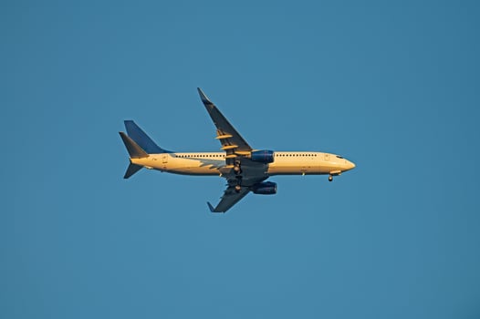A passenger plane landing. Passenger plane flying in the sky. Aircraft opening the landing gear. photo