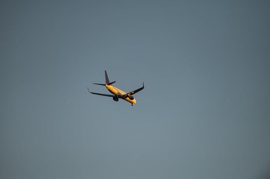 A passenger plane landing. Passenger plane flying in the sky. Aircraft opening the landing gear. photo