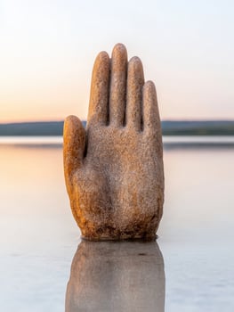 Serene hand sculpture at sunset photo