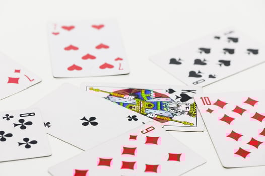 Colorful playing cards scattered on a white surface in an engaging game atmosphere photo