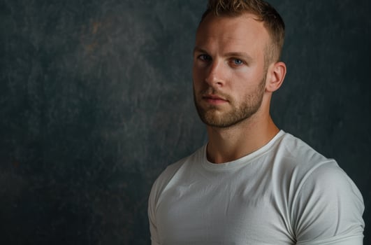 Serious young man with beard and blue eyes photo